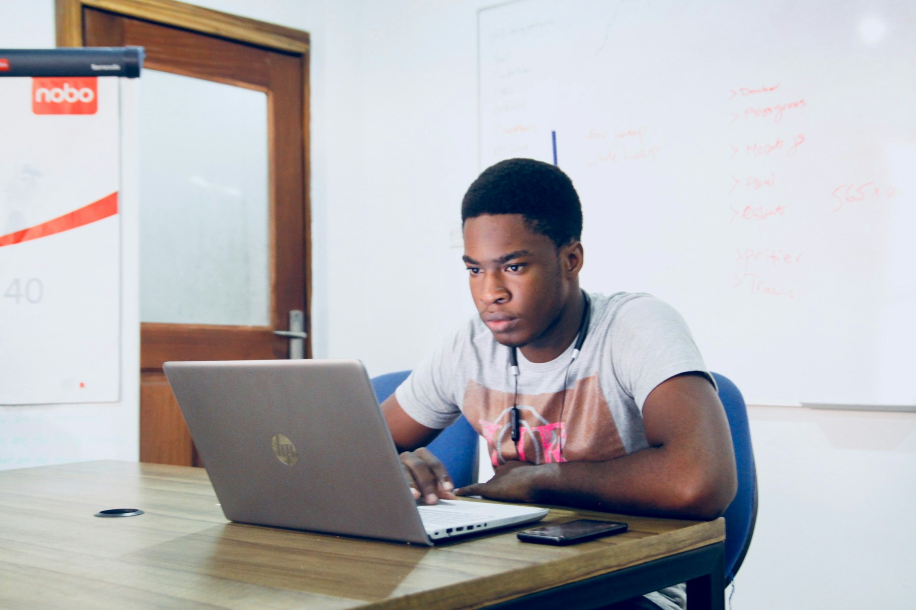A student building a software business on a laptop